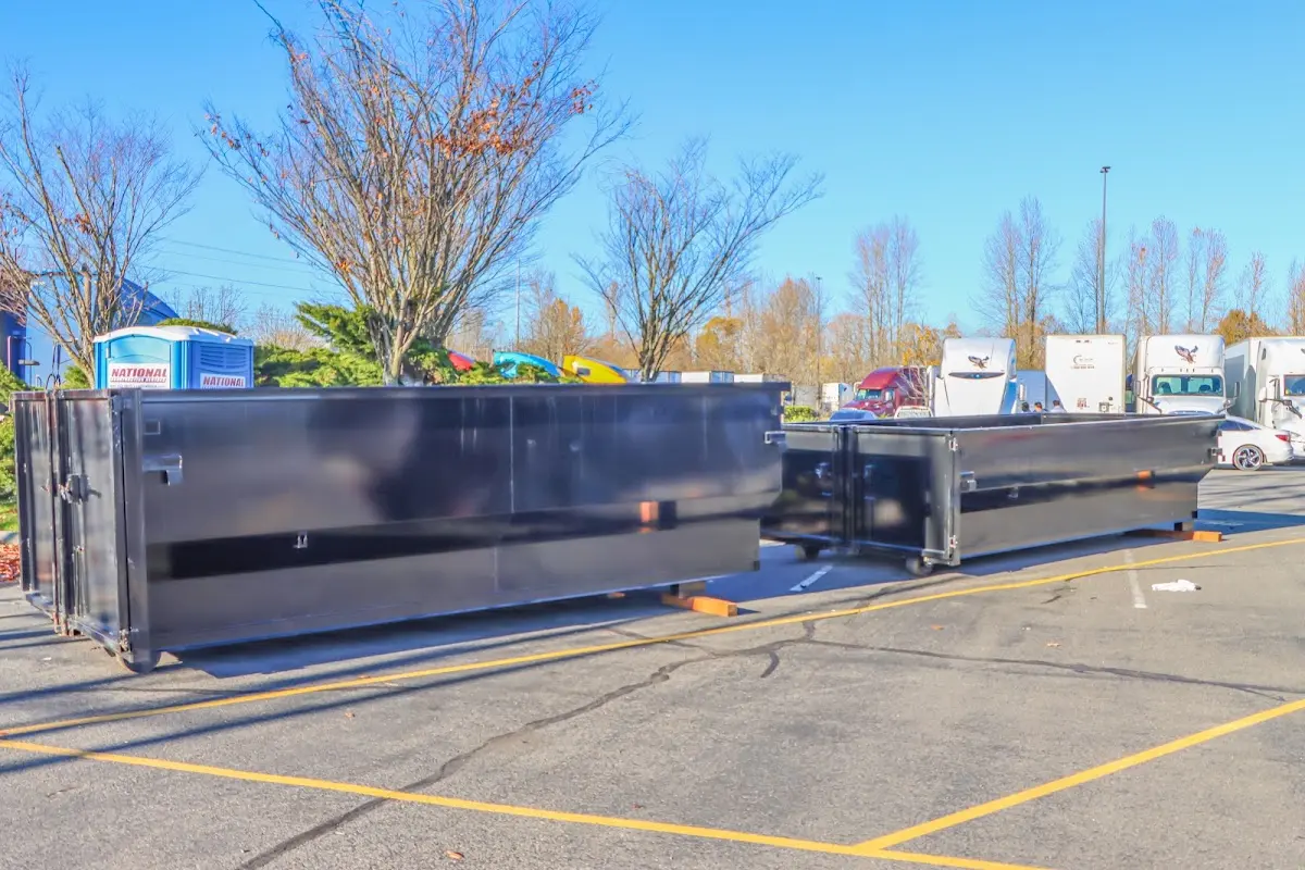 Professional dumpster rental service with roll-off container on residential driveway in Fraser